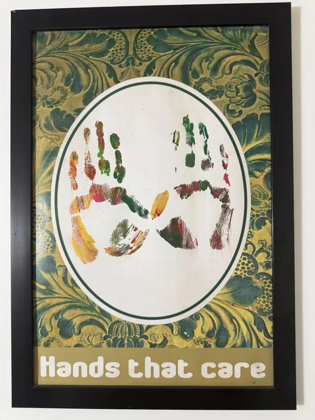 “Hands That Care” honour: a framed print of painted handprints